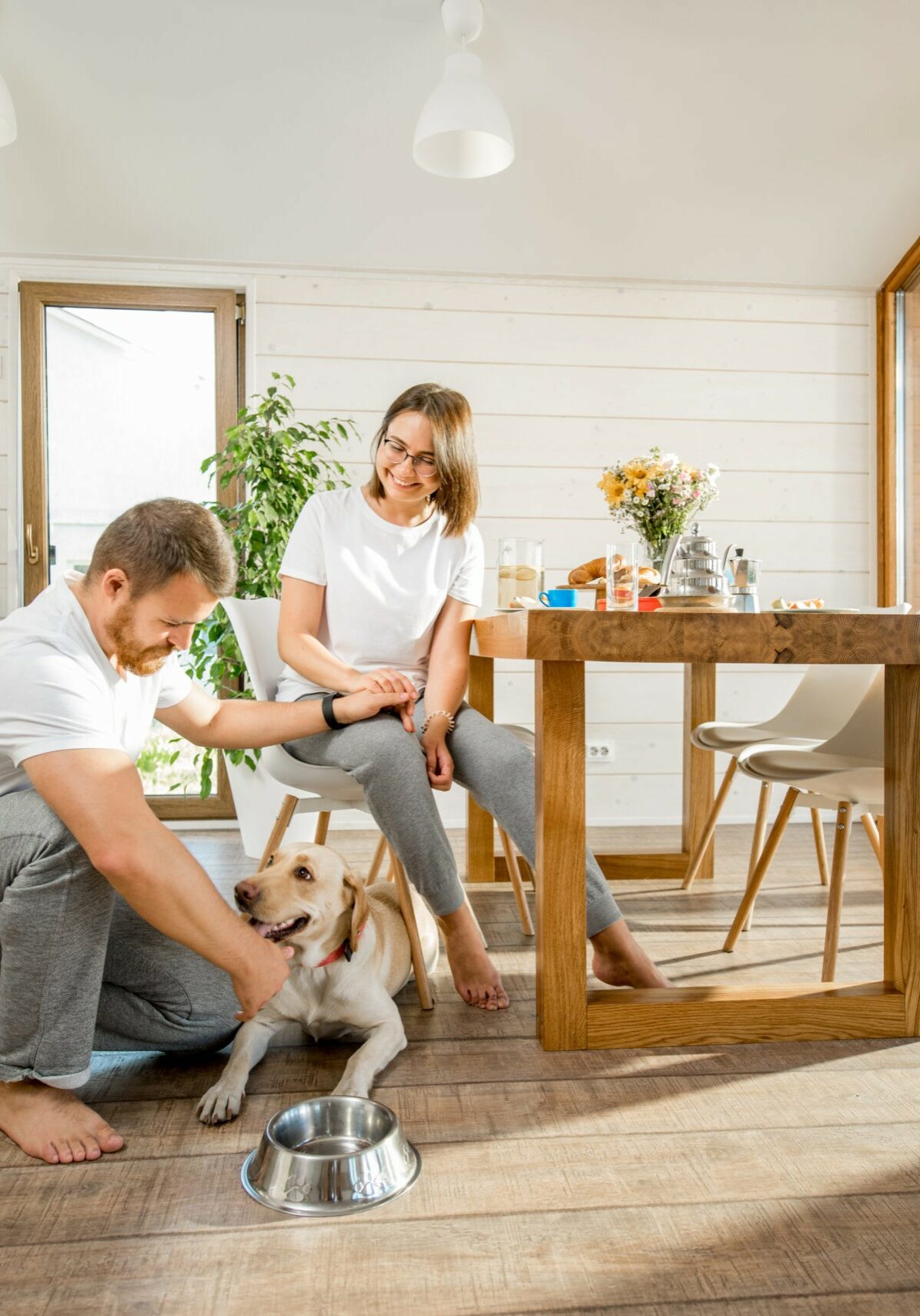 Young couple with dog at home | Floor Magic